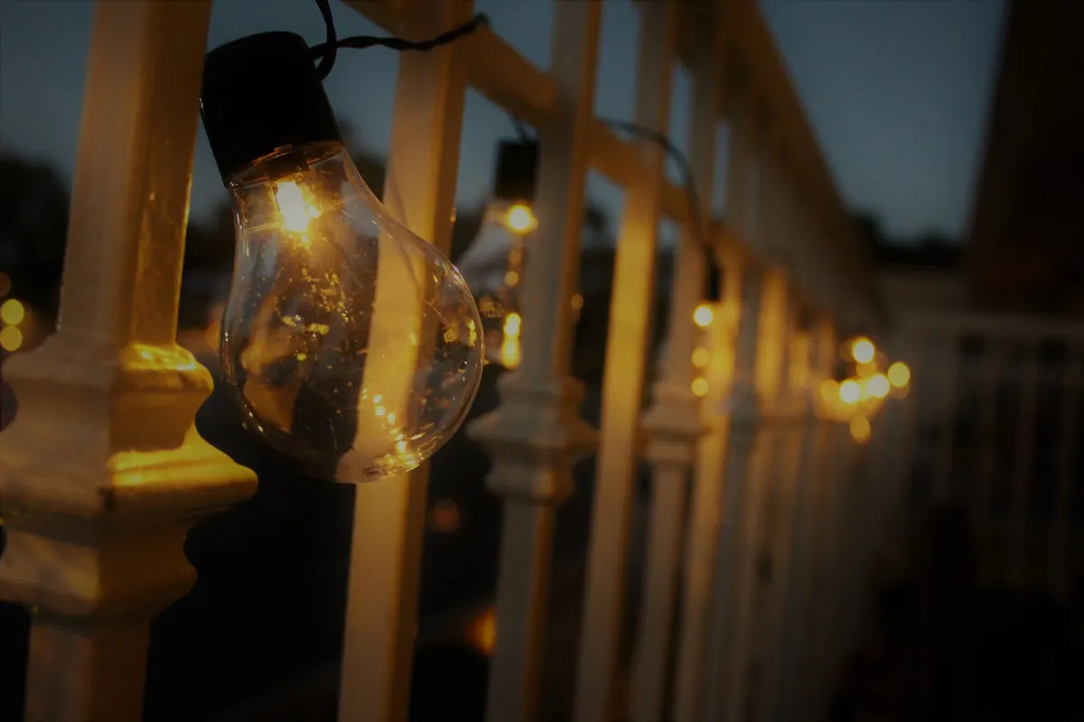 man holding incandescent bulb